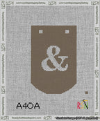 A taped needlepoint canvas with the design: Banner 13 mesh count Curved Ampersand White on Brown.
