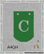A taped needlepoint canvas with the design: Banner 13 mesh count Curved C White on Green.
