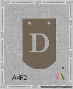 A taped needlepoint canvas with the design: Banner 13 mesh count Curved D White on Brown.