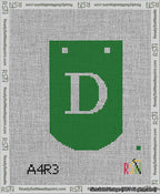 A taped needlepoint canvas with the design: Banner 13 mesh count Curved D White on Green.