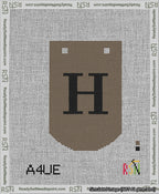 A taped needlepoint canvas with the design: Banner 13 mesh count Curved H Black on Brown.