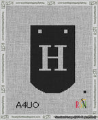 A taped needlepoint canvas with the design: Banner 13 mesh count Curved H White on Black.