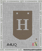 A taped needlepoint canvas with the design: Banner 13 mesh count Curved H White on Brown.