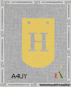 A taped needlepoint canvas with the design: Banner 13 mesh count Curved H White on Yellow.