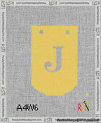 A taped needlepoint canvas with the design: Banner 13 mesh count Curved J White on Yellow.