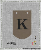 A taped needlepoint canvas with the design: Banner 13 mesh count Curved K Black on Brown.