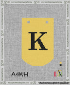 A taped needlepoint canvas with the design: Banner 13 mesh count Curved K Black on Yellow.