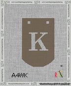 A taped needlepoint canvas with the design: Banner 13 mesh count Curved K White on Brown.
