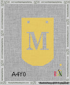 A taped needlepoint canvas with the design: Banner 13 mesh count Curved M White on Yellow.
