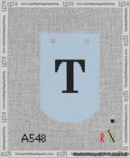 A taped needlepoint canvas with the design: Banner 13 mesh count Curved T Black on Light Blue.