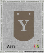 A taped needlepoint canvas with the design: Banner 13 mesh count Curved Y White on Brown.
