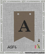 A taped needlepoint canvas with the design: Banner 13 mesh count Forked A Black on Brown.