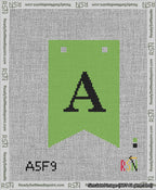 A taped needlepoint canvas with the design: Banner 13 mesh count Forked A Black on Light Green.