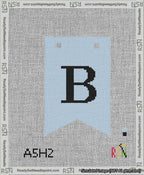 A taped needlepoint canvas with the design: Banner 13 mesh count Forked B Black on Light Blue.