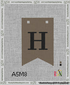 A taped needlepoint canvas with the design: Banner 13 mesh count Forked H Black on Brown.
