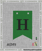 A taped needlepoint canvas with the design: Banner 13 mesh count Forked H Black on Green.