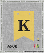 A taped needlepoint canvas with the design: Banner 13 mesh count Forked K Black on Yellow.