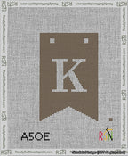 A taped needlepoint canvas with the design: Banner 13 mesh count Forked K White on Brown.