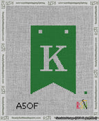 A taped needlepoint canvas with the design: Banner 13 mesh count Forked K White on Green.