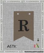 A taped needlepoint canvas with the design: Banner 13 mesh count Forked R Black on Brown.