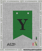 A taped needlepoint canvas with the design: Banner 13 mesh count Forked Y Black on Green.