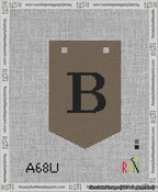 A taped needlepoint canvas with the design: Banner 13 mesh count Pointed B Black on Brown.