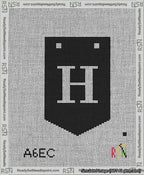 A taped needlepoint canvas with the design: Banner 13 mesh count Pointed H White on Black.