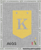 A taped needlepoint canvas with the design: Banner 13 mesh count Pointed K White on Yellow.