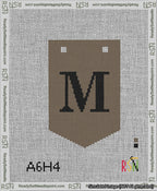 A taped needlepoint canvas with the design: Banner 13 mesh count Pointed M Black on Brown.