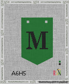 A taped needlepoint canvas with the design: Banner 13 mesh count Pointed M Black on Green.