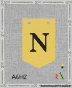 A taped needlepoint canvas with the design: Banner 13 mesh count Pointed N Black on Yellow.