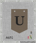 A taped needlepoint canvas with the design: Banner 13 mesh count Pointed U Black on Brown.