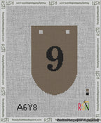 A taped needlepoint canvas with the design: Banner 13 mesh count Rounded 9 Black on Brown.