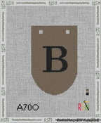 A taped needlepoint canvas with the design: Banner 13 mesh count Rounded B Black on Brown.