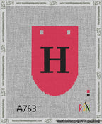 A taped needlepoint canvas with the design: Banner 13 mesh count Rounded H Black on Red.
