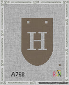 A taped needlepoint canvas with the design: Banner 13 mesh count Rounded H White on Brown.