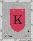 A taped needlepoint canvas with the design: Banner 13 mesh count Rounded K Black on Red.