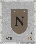 A taped needlepoint canvas with the design: Banner 13 mesh count Rounded N Black on Brown.