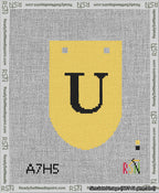 A taped needlepoint canvas with the design: Banner 13 mesh count Rounded U Black on Yellow.