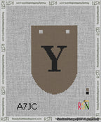 A taped needlepoint canvas with the design: Banner 13 mesh count Rounded Y Black on Brown.