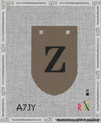 A taped needlepoint canvas with the design: Banner 13 mesh count Rounded Z Black on Brown.