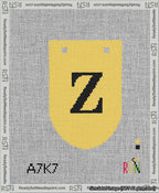 A taped needlepoint canvas with the design: Banner 13 mesh count Rounded Z Black on Yellow.