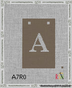 A taped needlepoint canvas with the design: Banner 13 mesh count Squared A White on Brown.