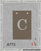 A taped needlepoint canvas with the design: Banner 13 mesh count Squared C White on Brown.