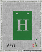 A taped needlepoint canvas with the design: Banner 13 mesh count Squared H White on Green.