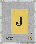 A taped needlepoint canvas with the design: Banner 13 mesh count Squared J Black on Yellow.
