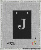 A taped needlepoint canvas with the design: Banner 13 mesh count Squared J White on Black.