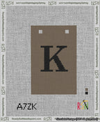 A taped needlepoint canvas with the design: Banner 13 mesh count Squared K Black on Brown.