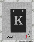 A taped needlepoint canvas with the design: Banner 13 mesh count Squared K White on Black.