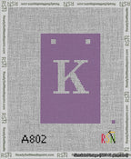 A taped needlepoint canvas with the design: Banner 13 mesh count Squared K White on Purple.